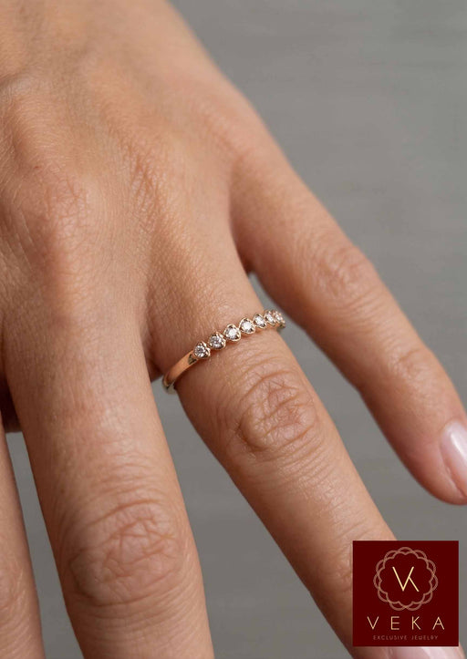 Veka Jewelry 10K yellow gold heart-shaped natural diamond stackable band worn on a model's hand.