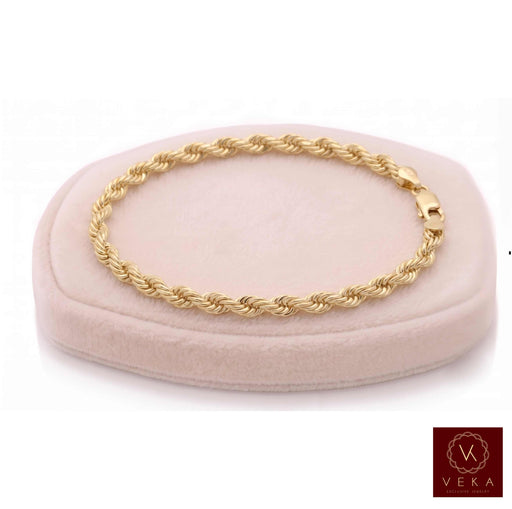 4.5mm genuine 10k yellow gold rope chain bracelet (9 inches) displayed on a beige stand by Veka Jewelry.