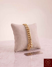 VEKA Jewelry 9mm Miami Cuban link bracelet in authentic 14K solid yellow gold displayed vertically on a beige velvet jewelry pillow