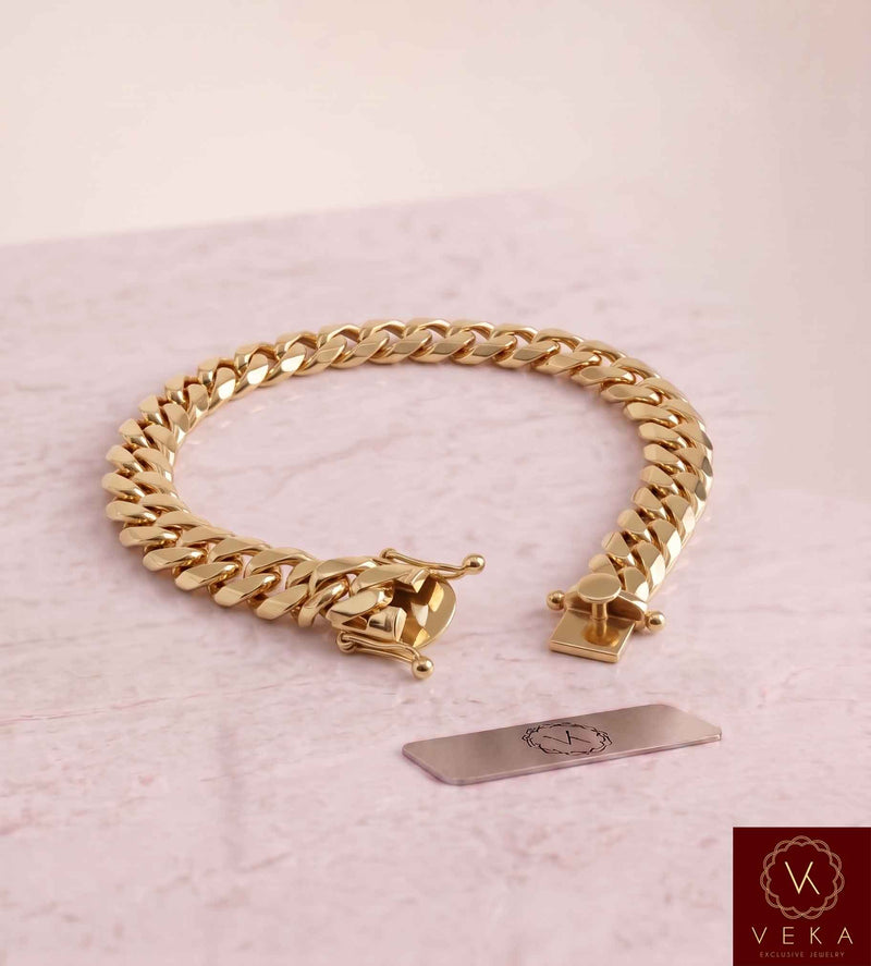 VEKA Jewelry 9mm Miami Cuban link bracelet in authentic 14K solid yellow gold displayed on a  luxurious marble stone with the Veka Jewelry Tag logo.