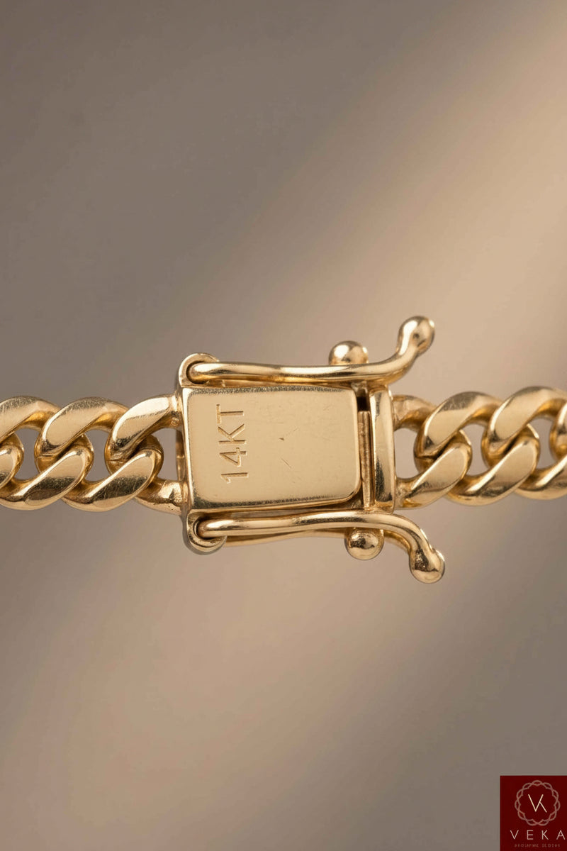 Extreme close-up macro shot of the secure 14KT box lock clasp with safety wings on a 6mm solid gold Miami Cuban link chain by Veka Jewelry