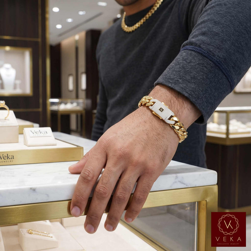 Man wearing a 13mm real 14k gold Monaco bracelet standing inside a Veka Jewelry store.
