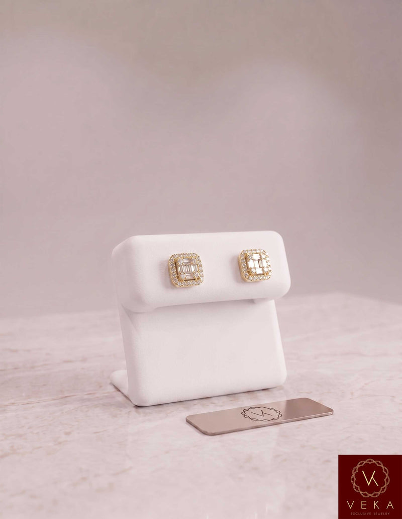 Veka Jewelry men's square halo stud earrings in 10k solid yellow gold with brilliant square and round moissanite stones, displayed on a white stand with a logo plaque.