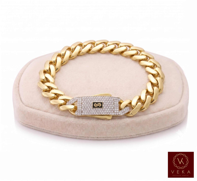 Real 14k gold Monaco chain bracelet for men, 13mm width, showcased on a beige soft velvet  display stand by Veka Jewelry