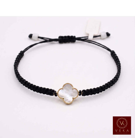 VEKA Jewelry black macrame cord bracelet featuring a gold clover motif set with white mother of pearl on a clean white background