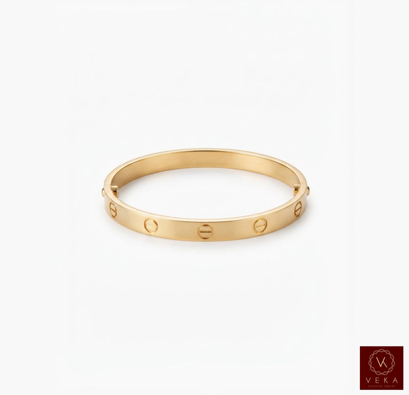 Luxury yellow gold screw bangle bracelet displayed on a clean white studio background by Veka Jewelry