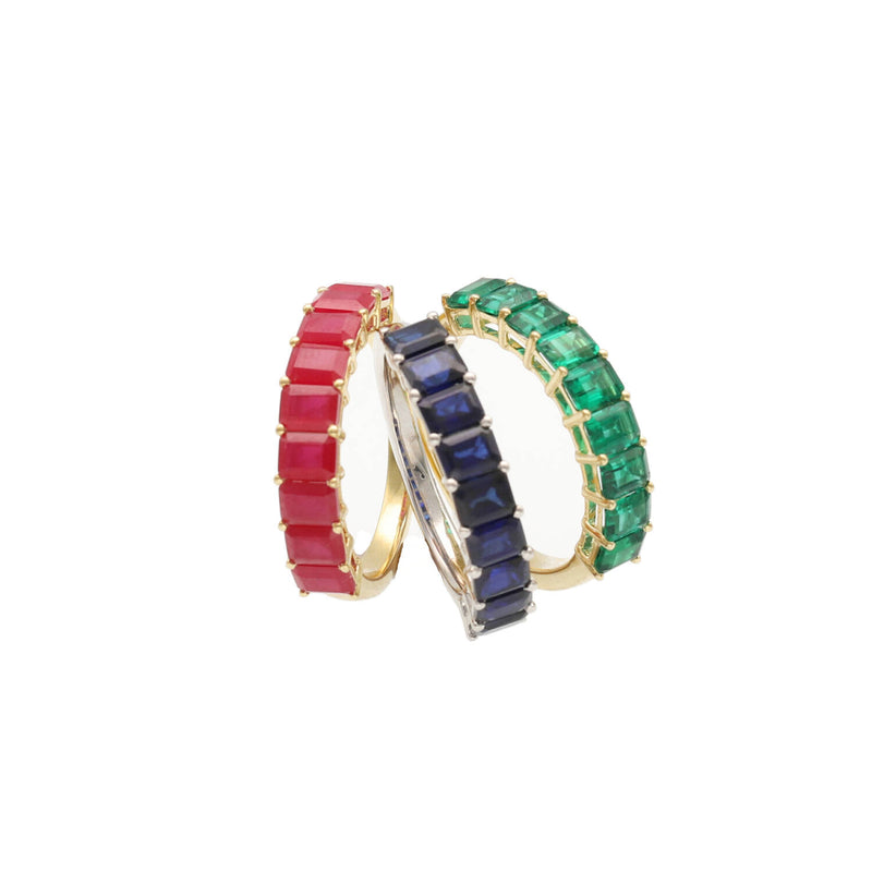 Vertical stack of three VEKA eternity bands in natural ruby, sapphire, and emerald gemstones