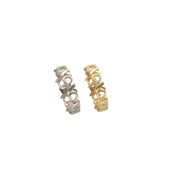 Side-by-side view of 5mm XOXO eternity rings in 14k white gold and 14k yellow gold.