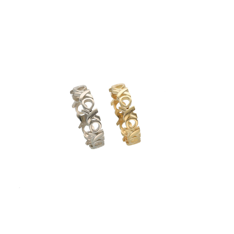 Side-by-side view of 5mm XOXO eternity rings in 14k white gold and 14k yellow gold.