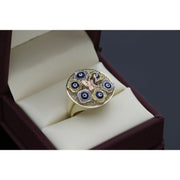 Angled view of a 10K gold butterfly ring with protective evil eye symbols and sparkling stone accents