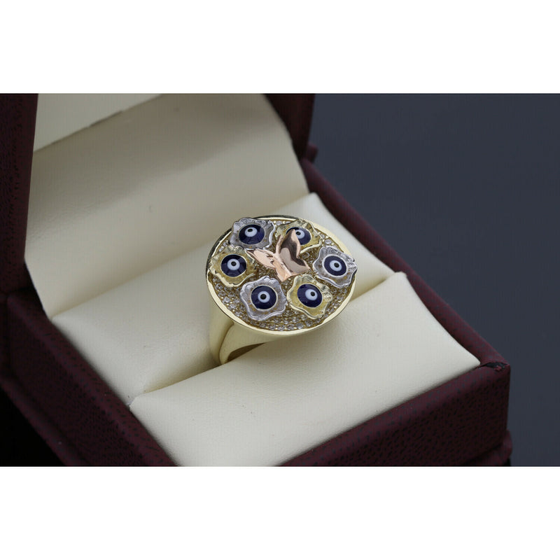 Angled view of a 10K gold butterfly ring with protective evil eye symbols and sparkling stone accents