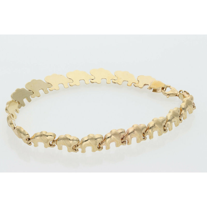 A high-quality 10K yellow gold elephant stampato bracelet with 8mm wide links and a lobster clasp displayed on a professional white jewelry tray.