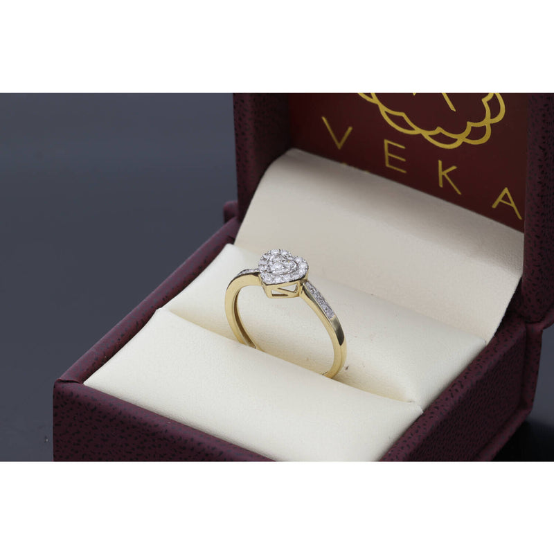 A three-quarter view of the fine jewelry diamond heart ring, highlighting the polished 1.7-gram 10K yellow gold band and the raised setting of the natural diamond heart cluster within the gold box