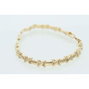 Professional product shot of a 7-inch yellow gold XOXO Hugs & Kisses bracelet on a clean white background.