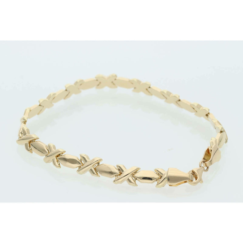 Professional product shot of a 7-inch yellow gold XOXO Hugs & Kisses bracelet on a clean white background