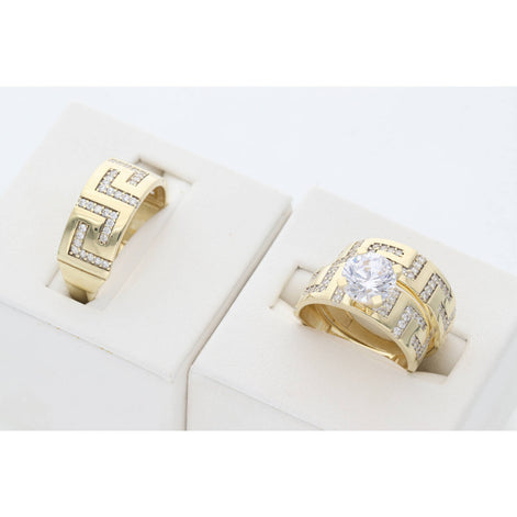A 10 karat gold trio wedding ring with gemstone zirconium and maze carving, displayed in a white setting.