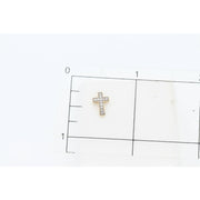 A 10K solid gold diamond cross stud earring positioned next to a metric ruler, clearly illustrating its 10mm height and subtle, elegant proportions