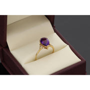 14K yellow gold purple amethyst zircon ring with teardrop solitaire setting - elegant birthstone alternative by VEKA JEWELRY on a leatherette ring box dislpay,
