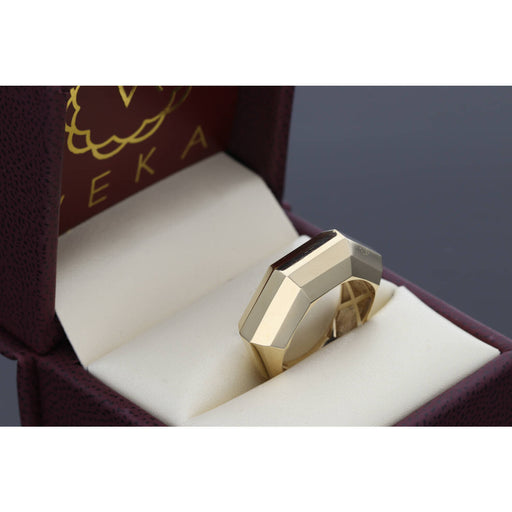 14K gold geometric ring with architectural Close-up view of 14K gold geometric ring showing angular facets and contemporary architectural design with clean lines