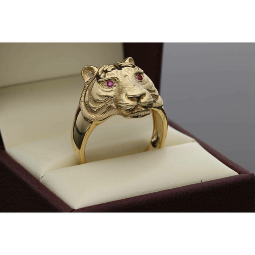 Front view of a men's gold tiger ring resting in a box, featuring detailed fur texture and bright red synthetic ruby eyes