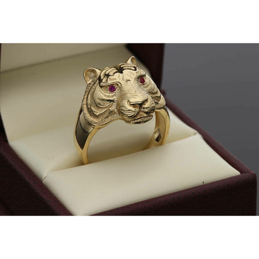 Front view of a men's gold tiger ring resting in a box, featuring detailed fur texture and bright red synthetic ruby eyes