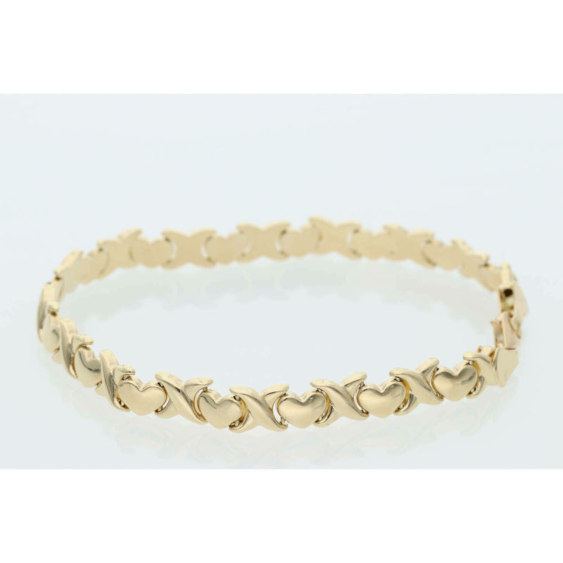 Close-up of a 6.1g 14K yellow gold stampato bracelet featuring alternating X and Heart links on a white background.