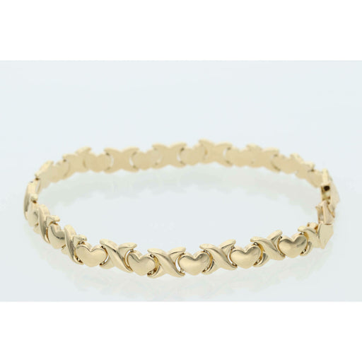 Close-up of a 6.1g 14K yellow gold stampato bracelet featuring alternating X and Heart links on a white background.