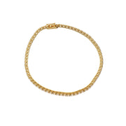 Close-up of 67 natural diamonds set in a classic 14K yellow gold 4-prong tennis bracelet.