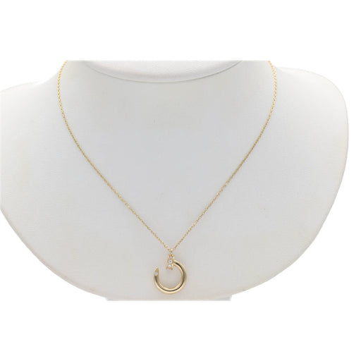 Gold Rolo chain in 14 Karat Gold Paired with a Nail Pendant displayed in a white neck
