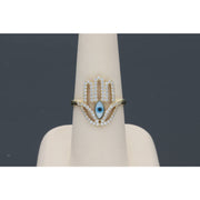 Hamsa Gold Band with Blue eye on the center. Surrounded by CZ stones.