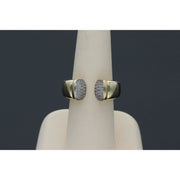 Elegant and  affordable 14 karat gold ring with opulent ends with stones encrustations, featuring a split band design, displayed on a beige ring stand against a dark background.