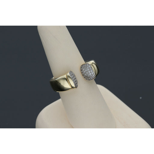 Elegant and  affordable 14 karat gold ring with opulent ends with stones encrustations, featuring a split band design, displayed on a beige ring stand against a dark background.