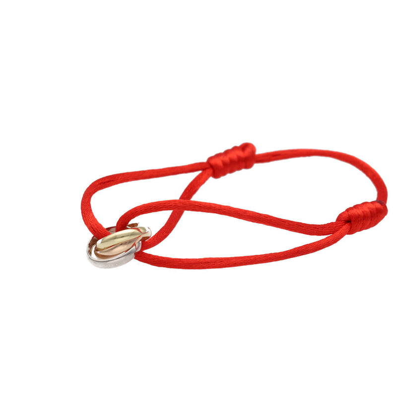 Red macrame cord bracelet with 14K yellow white rose gold bands displayed flat showing handcrafted details