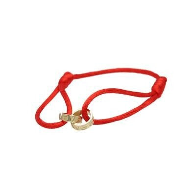 14K gold two band red macrame bracelet with adjustable screw design showing handcrafted red cord weaving