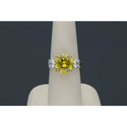 Yellow gold citrine ring with diamond-like zircon side stones - elegant three stone design in a ring display with dark gray blackground