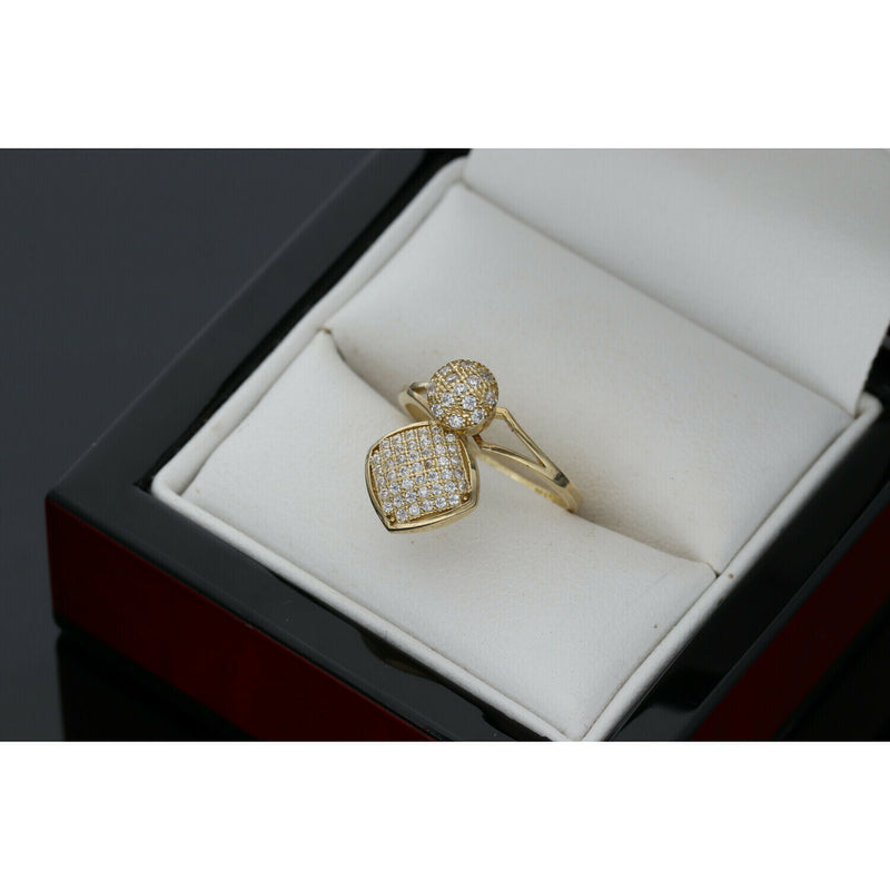 10K gold spinner ring with circle and heart charms featuring zirconium stones in white jewelry box"