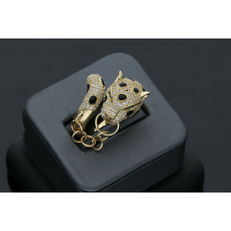 Iconic Leopard Design on this ring adorned with stones all over. Also including a chain joining both ends of the ring sit on a dark ring holder on a black background. VEKA JEWELRY