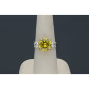 Yellow gold citrine ring with diamond-like zircon side stones - elegant three stone design in a ring display with dark gray background