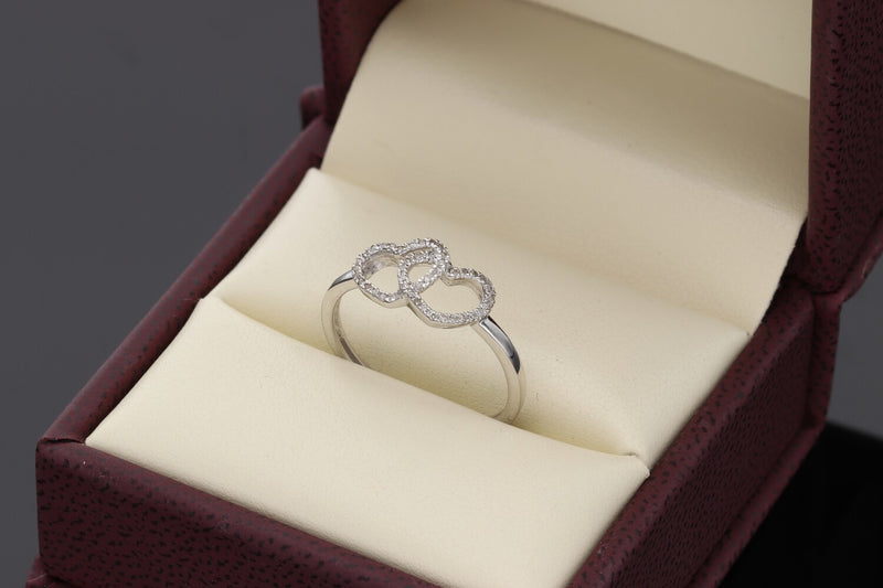 Top view of the entwined hearts diamond ring in 14k white gold, showing the 0.10ctw diamond detailing and SI quality stones