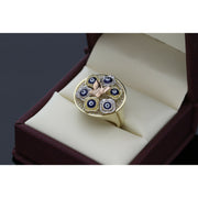 Close-up view of 10K gold evil eye butterfly ring showing six blue evil eye motifs surrounding rose gold butterfly centerpiece