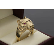 Side profile of a 14K gold tiger ring showing the depth of the animal design and the solid gold band construction on a leatherette box