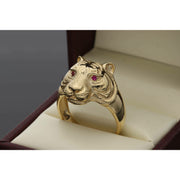 Side profile of a 14K gold tiger ring showing the depth of the animal design and the solid gold band construction on a leatherette box