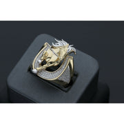 Detailed view of a men's heavy 14k yellow gold ring featuring a leaping horse with white gold accents set within a horseshoe paved with clear cubic zirconia stones on a black ring display