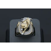 Detailed view of a men's heavy 14k yellow gold ring featuring a leaping horse with white gold accents set within a horseshoe paved with clear cubic zirconia stones on a black ring display