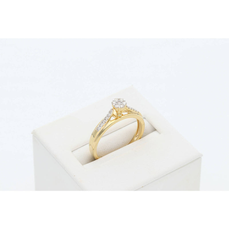 Side profile view of VEKA 14K yellow gold engagement ring showing 0.25 diamond cluster setting.