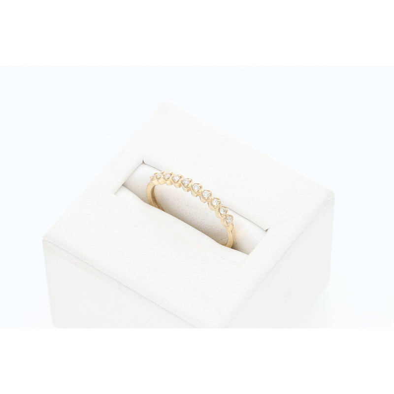 Angled profile view of a dainty 10K yellow gold diamond heart-shaped stackable wedding band by Veka Jewelry