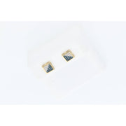 Detailed top-down close-up photograph of a pair of Veka Jewelry square geometric stud earrings, featuring a central black diamond and a frame of smaller white diamonds in yellow gold