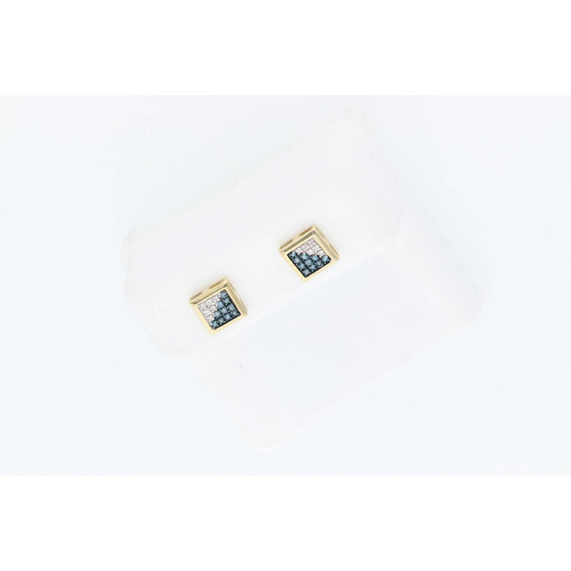 Detailed top-down close-up photograph of a pair of Veka Jewelry square geometric stud earrings, featuring a central black diamond and a frame of smaller white diamonds in yellow gold