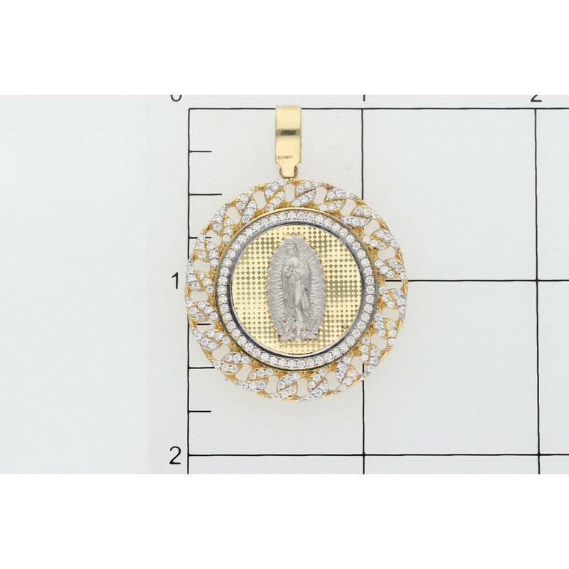 A clear verification shot showing the Veka Jewelry 14K Gold Virgen de Guadalupe Medallion Pendant positioned on a measurement grid, allowing customers to easily confirm the physical size and dimensions of the pendant